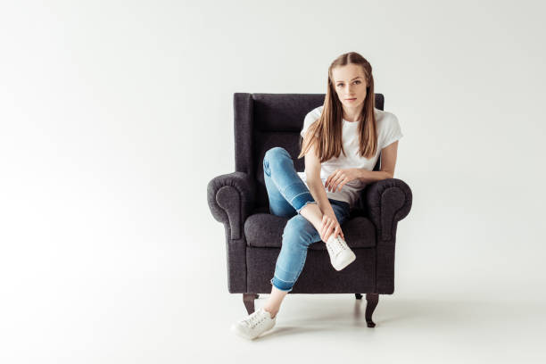 Beautiful Girl sitting on gray armchair