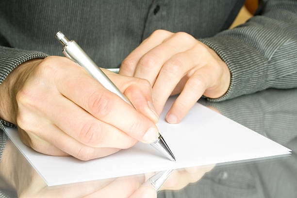 istock hand with pen and paper 91616768