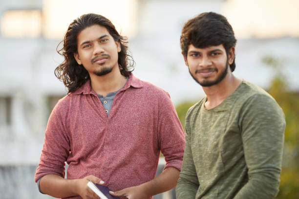 istock Happy young people chatting with book 916170872