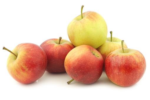 fresh red and yellow apples on a white background