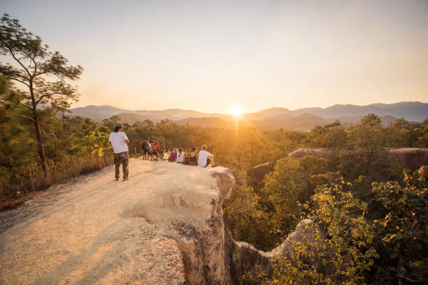 Tourists enjoy the sunset at Pai Canyon, Pai, Thailand stock photo