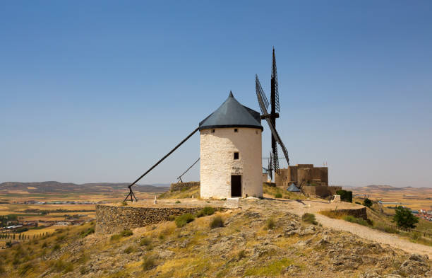 istock CONSUEGRA, SPAIN . JUNE 24, 2016 Group of windmills in Campo de Criptana and Castillo de la Muela on the background. La Mancha, Consuegra, Don Quixote route, Spain, Europe 916173052
