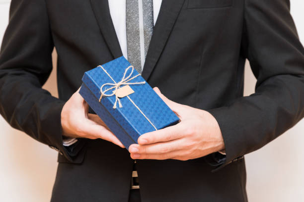 istock A man holding a gift box in his hands 916175824