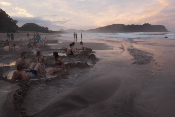 Hot Water Beach Hot Water Beach, New Zealand - September 27, 2017: People enjoy the hot water springs in the Hot Water Beach in New Zealand North Island coromandel peninsula stock pictures, royalty-free photos & images
