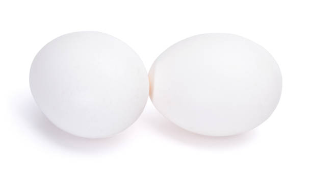 istock Group of two white eggs isolated on white background 916185040