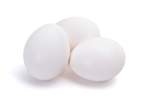 istock Group of three white eggs isolated on white background 916185054