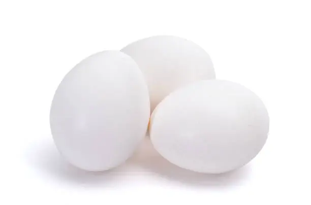 Photo of Group of three white eggs isolated on white background