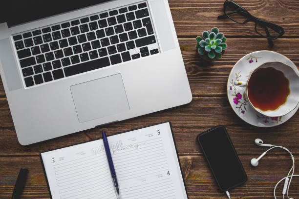 istock Working place with laptop on wooden table 916188246