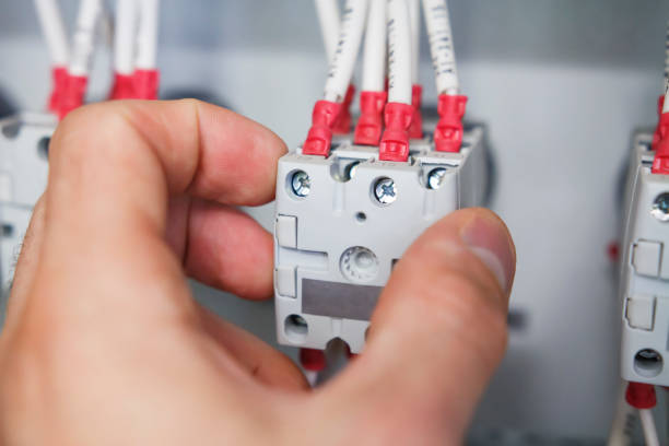 istock hand of electrician installs package switch with connected wires in electric control panel close up. 916188840