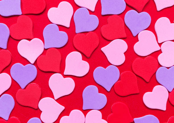 istock Bright multicoloured love hearts on red background. Valentines day card. 916189092