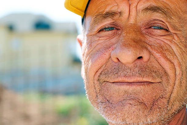 istock Old wrinkled man with yellow cap 91618928