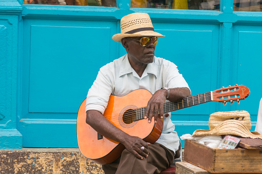 HAVANA, CUBA - JANUARY 16, 2017: Street musician perform for tourists and tips in Old Havana, Havana, Cuba