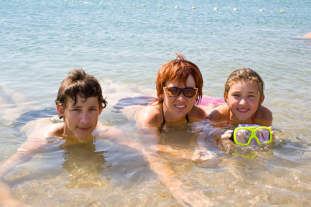 istock Children with mother on the beach 91619225