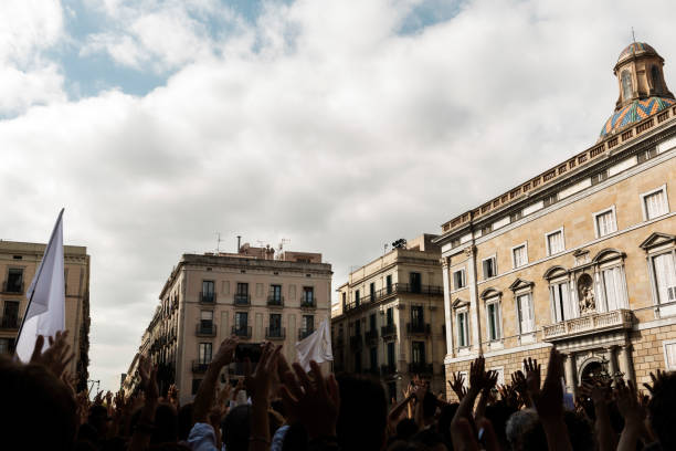 istock mass protest of people with raised hands and flags 916200526
