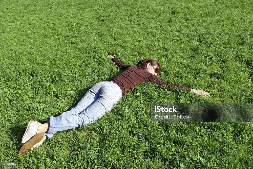 Calm Girl on grass. Element of design. Face Down Stock Photo