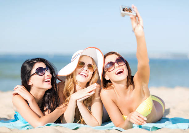 istock girls taking self photo on the beach 916209024