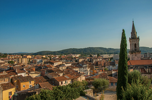 View of the lively and gracious town of Draguignan from the hill of the clock tower, under the colorful light of the sunset.