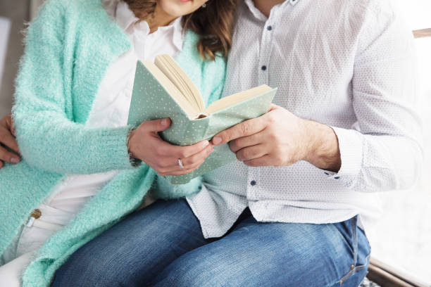 Man and a woman  reading book together