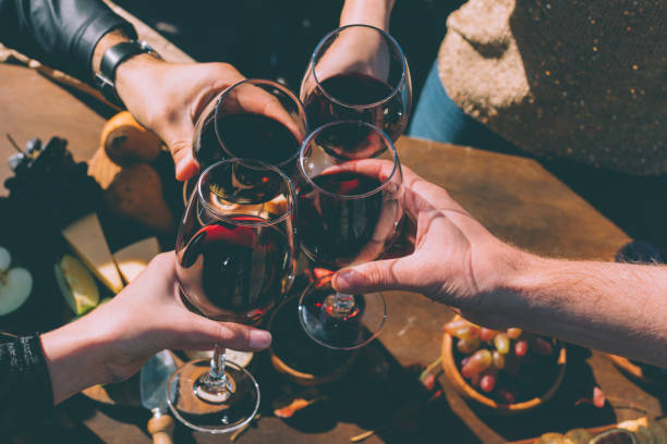 istock people clinking glasses of delicious red wine 916219878