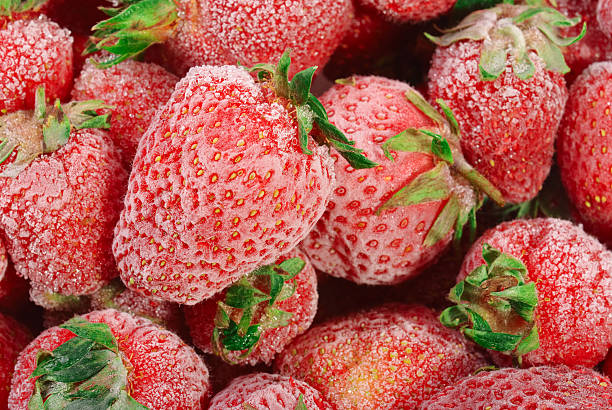 Frozen strawberries with frost on them stock photo