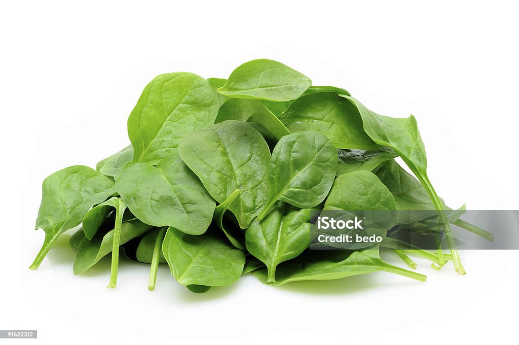 Pile of baby spinach leaves on white Young spinach leaves in isolated white background Spinach Stock Photo