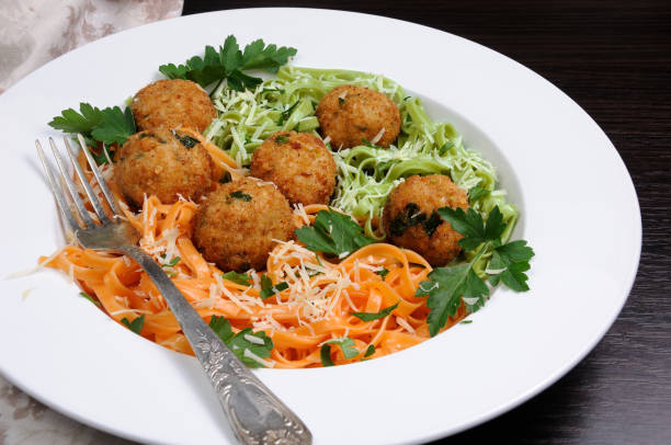 istock Spaghetti from carrots and spinach with chicken meatballs flavored cheese parmesan, herb 916224272