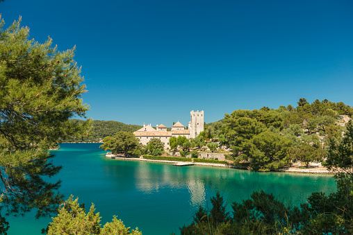 The Benedictine monastery on small island in the large lake on island of Mljet, sunny summer day. Croatia.