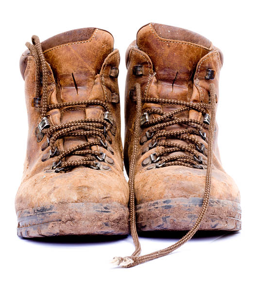 istock Pair of worn brown work boots on white background 91622712