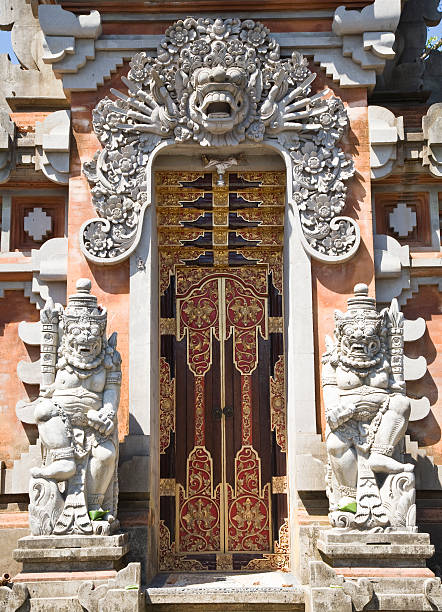 Traditional balinese handmade carved wooden door. Bali style furniture with ornament details\n\nTirta Empul temple is an ancient Hindu Balinese water temple located near the town of Tampaksiring, Bali, Indonesia.