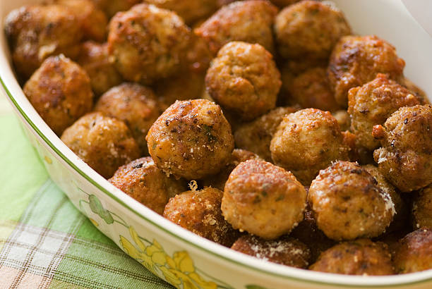 Meatballs with tomato sauce in iron frying pan isolated on white background