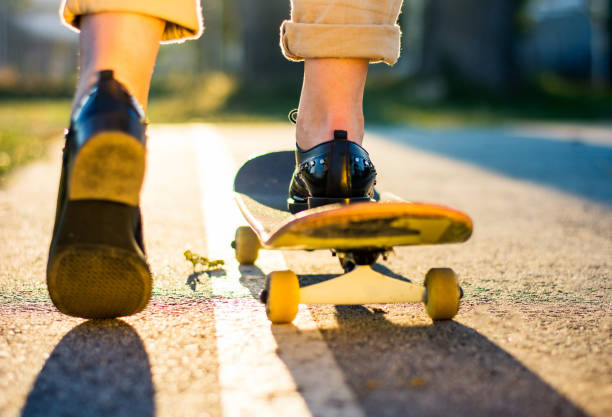 istock Female riding a skateboard at sunset 916231494