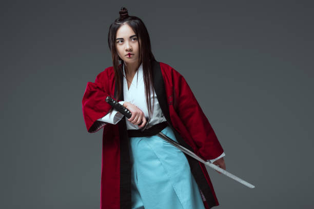 istock samurai in kimono holding katana sword isolated on grey 916233878