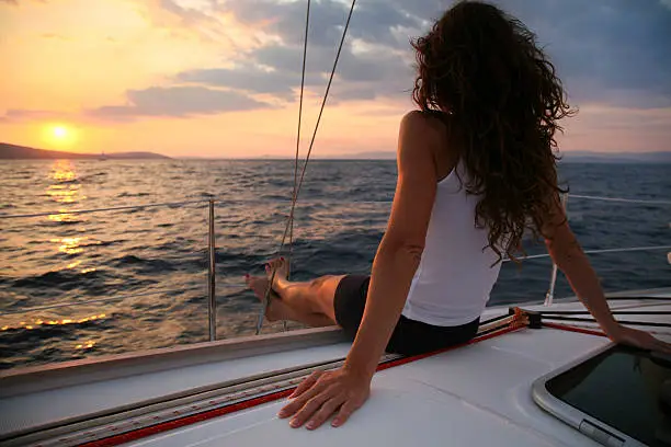 Attractive woman sailing and looking at sunset-Hvar Island-Croatia