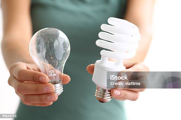 Hands Holding Traditional And Energy Efficent Lightbulbs Stock Photo - Download Image Now