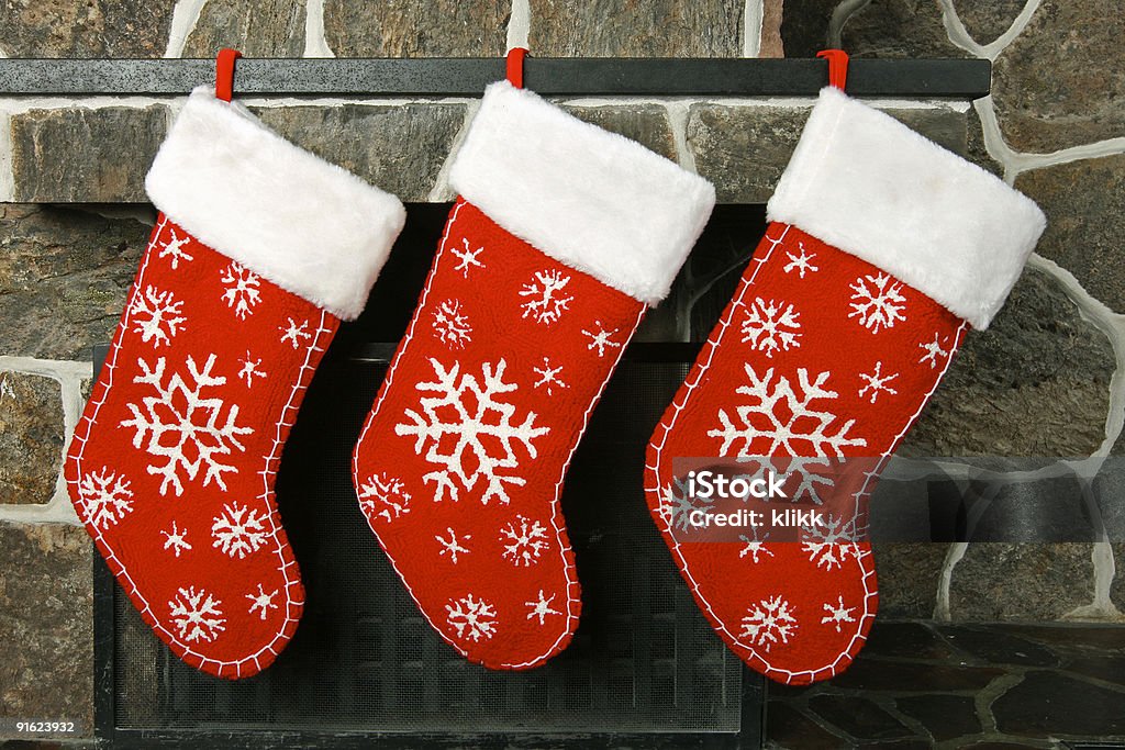 Close-up of three empty Christmas stockings hanging in a row Christmas stockings on a fireplace mantel Christmas Stocking Stock Photo