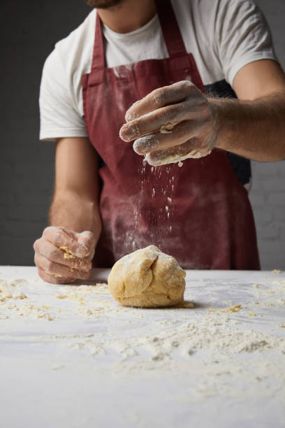 istock cropped image of chef preparing dough in kitchen 916241848