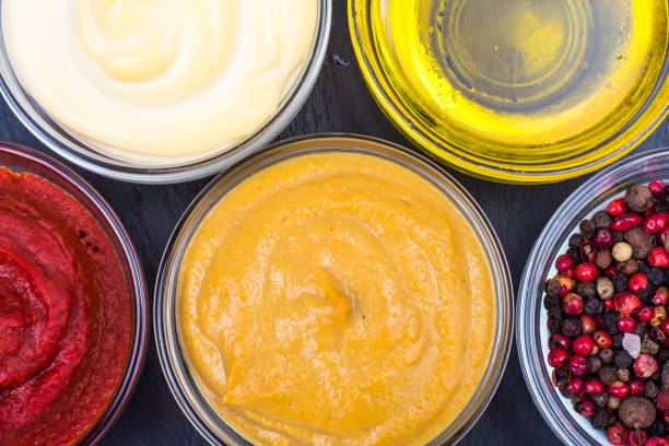 istock Set of sauces and spices on black background 916242440