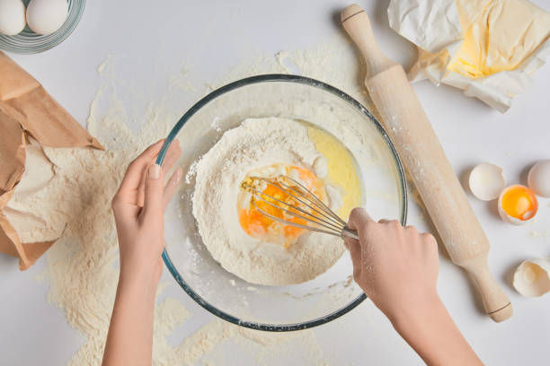 istock cropped image of chef preparing dough and whisking flour and eggs 916242448