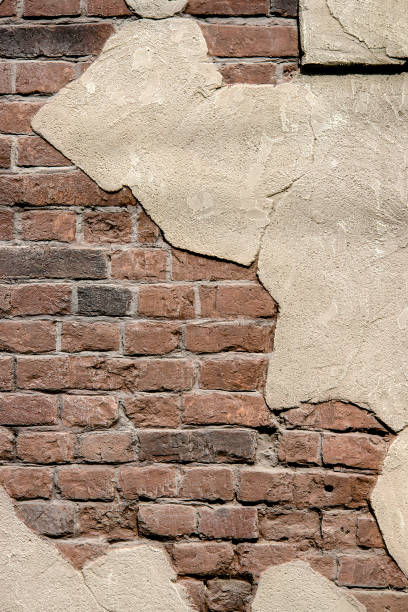 istock Old brick wall with the bits of plaster. 916242474