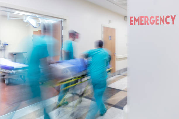 Doctor wheeling patient Doctor wheeling patient emergency room photos stock pictures, royalty-free photos & images