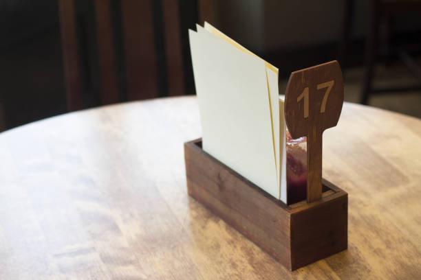 detail of restaurant table setting top view of restaurant table setting with ketchup wood box and white blank menu pages pub table top view stock pictures, royalty-free photos & images