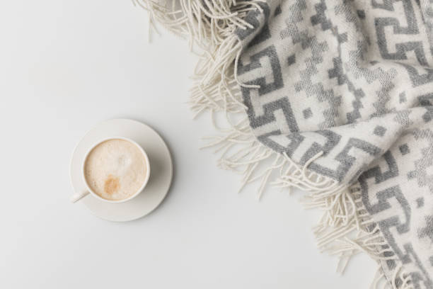 top view of coffe cup and blanket isolated on white