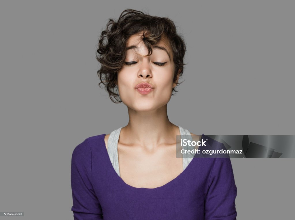 Portrait de jeune femme souffle un baiser - Photo de Faire la moue libre de droits