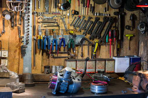 Motorcycle parts and tools on the desktop in the garage