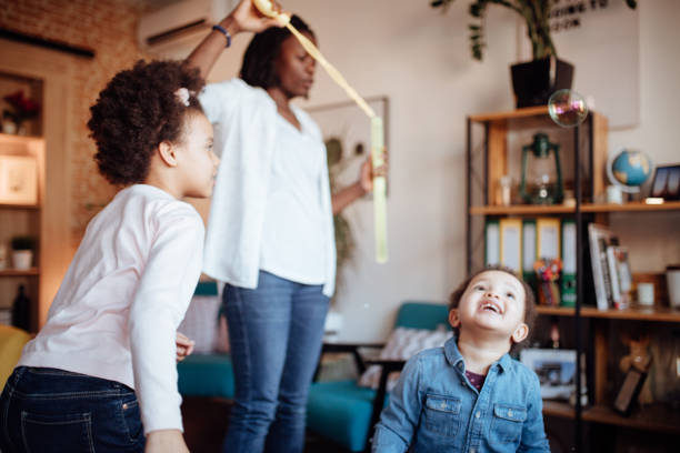 istock Cute family playing with soap bubbles 916248936