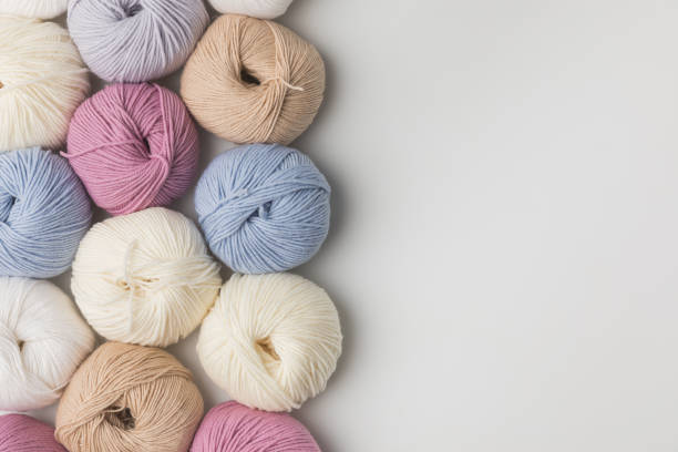 istock colored yarn balls in a row isolated on white background 916249126