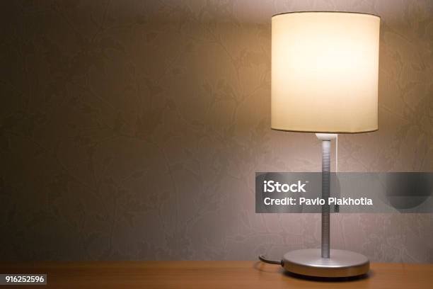 Table Lamp Over White Wall Background Modern Minimalistic Night Light For Bedroom Interior Stock Photo - Download Image Now