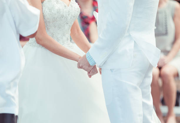 istock Bride and groom holding hands 916252890
