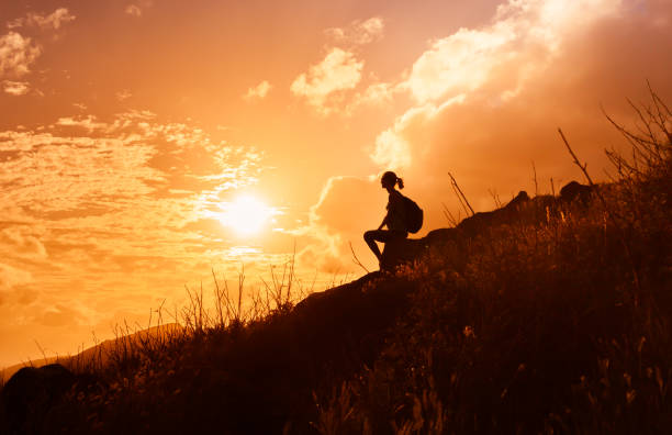 istock Woman enjoying beautiful sunset. 916253074