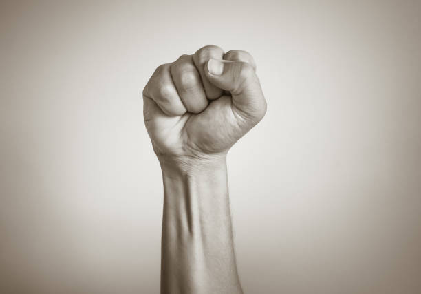 Male fist in the air isolated on white background. People, power, protest concept. punching the air stock pictures, royalty-free photos & images